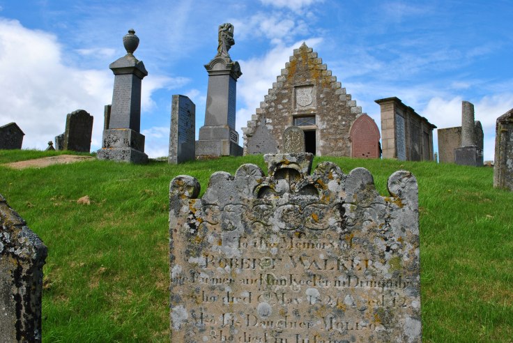 The north wall, standing up to 3m high, and the porch (Elphinstone aisle) dating from 1605 are all that remain of the former St Bride’s church - once called the 'chapel of the lochs' from the marshland that encircled the glacial mound. It is thought to date from 1335 AD or earlier. Within the north wall there is a medieval gothic-arched grave recess to the 3rd Laird of Brux and his wife.