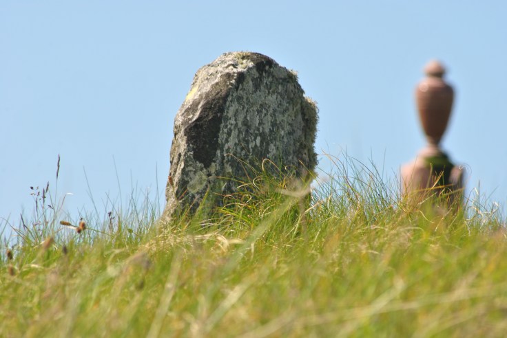 moss covered headsone on a hill